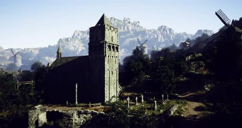 Antigua iglesia de piedra en la ladera rodeada de montañas y molinos de viento