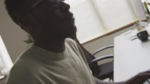 African American Programmer Writing Code on Computer