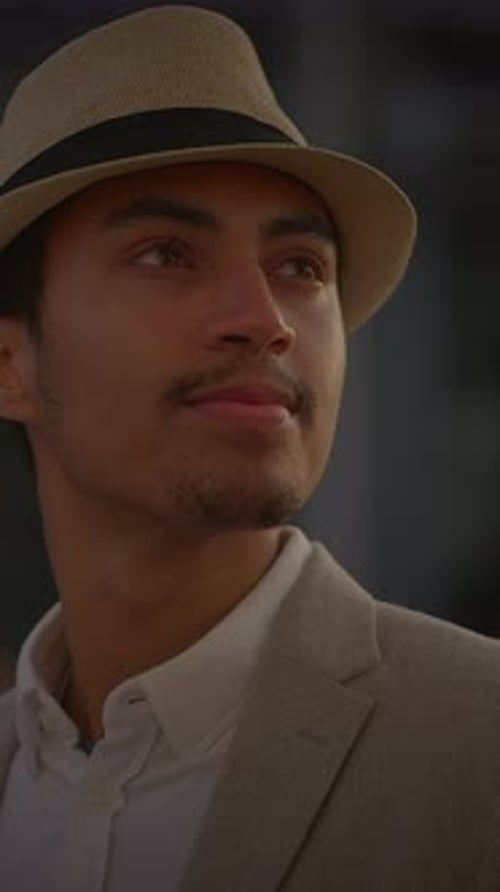 Stylish Man Wearing a Hat and Blazer Outdoors