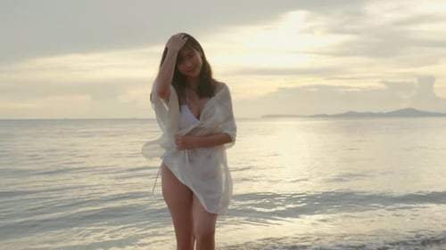 Woman Wear Bikini Swimsuit with Blowing Sarong Enjoying Walking and Spin Body at Beach