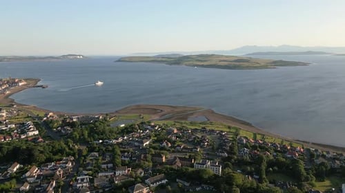 Aerial View of a Coastal Town Overlooking a Scenic Island and Blue Ocean
