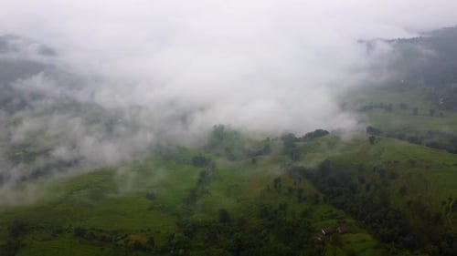 Misty Clouds Over Green Valleys In Nepal, South Asia. Aerial Drone Shot