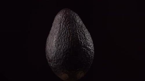 Avocado on a black background. Avocado close-up. Fresh avocado.