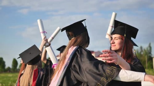 Two College Graduates Hugging on a Sunny Day