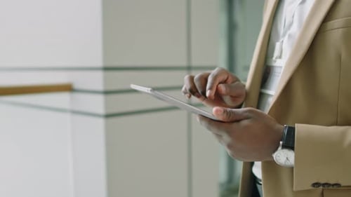 Businessman Using Tablet in Modern Office Space
