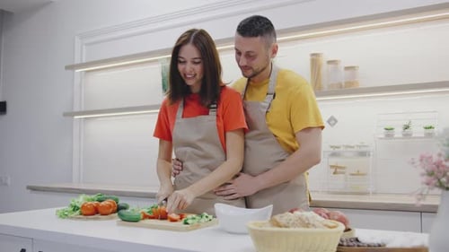 Happy Couple Cooking Food Together in Kitchen