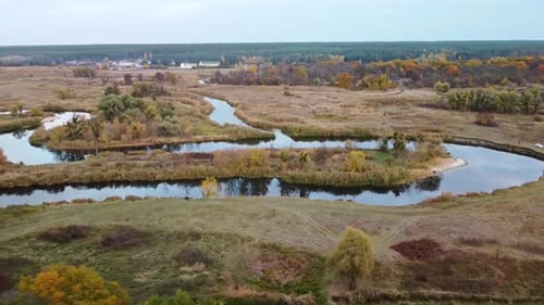 Aerial view on river curve in autumn valley