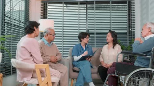 Caregiver Talking to Seniors in Indoor Setting