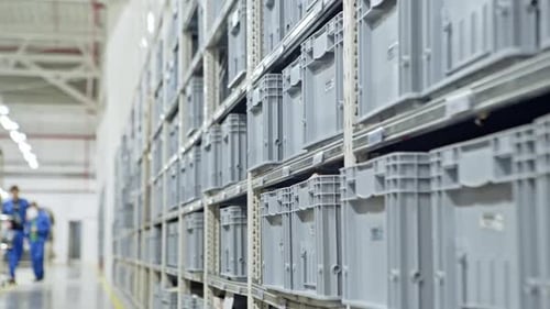 Modern Warehouse with Plastic Gray Boxes on the Production