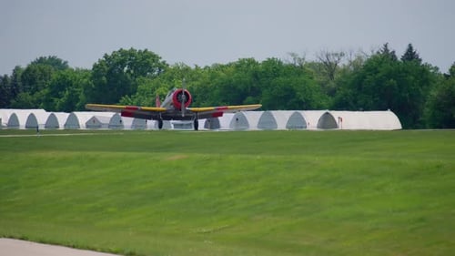 A Propeller Plane is Landing at the Small Airport Green Bright Summer Day