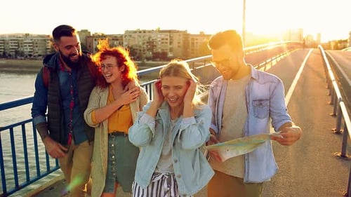 Group of tourists enjoying on vacation, young friends having fun walking on city street.
