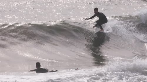 Male Surfer Riding a Wave