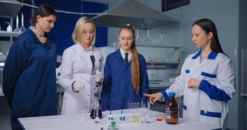Young Women Conduct Scientific Experiment in Laboratory