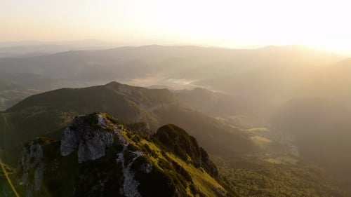 An Aerial Ideo Slow Dollyout Motion Revealing a Majestic Mountain Peak and Its Surroundings