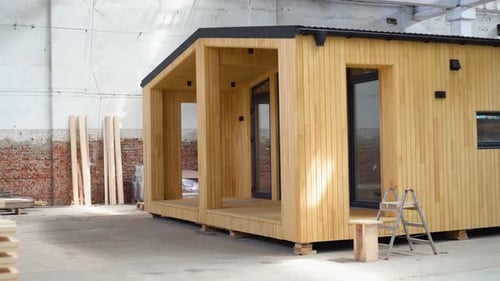 A New Wooden Modular Prefabricated House Inside an Industrial Building