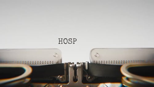 Old mechanical typewriter typing Hospital in a close-up view.