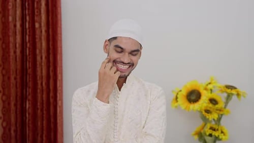 Young Man Thinking and Smiling Indoors