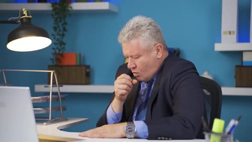 Stressed Man at Desk in Office