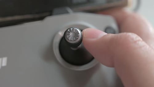 Finger operating Drone Remote Control Joystick Close Up