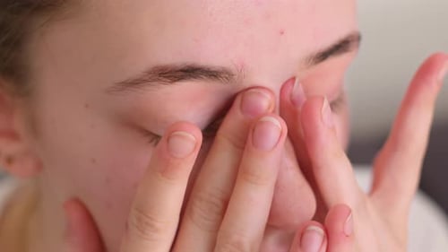 Woman Gently Massaging Skin Around Her Eyes