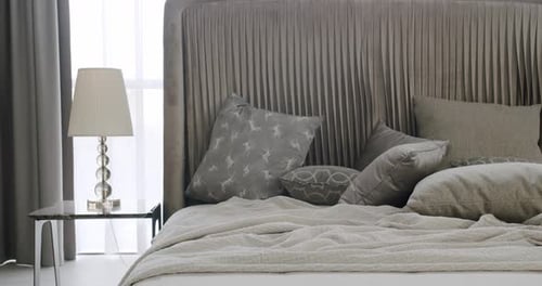 Calm Bedroom Interior with Pillows and Lamp