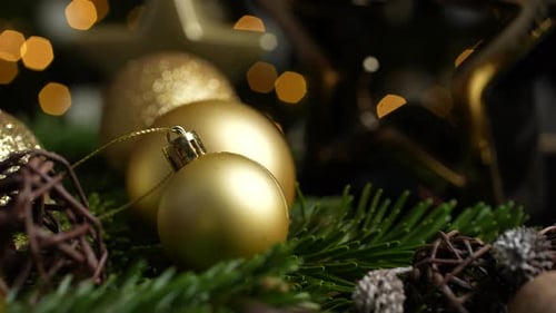 Golden Christmas Ornaments and Twinkling Lights Close-Up
