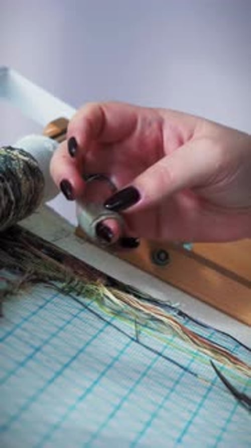 Woman stitching embroidery of nature, close up. Vertical video