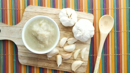 Top View of Garlic Paste on a Chopping Board on Table