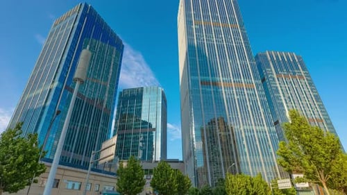 Close High Angle View Of The Glass Mirrored Buildings. Business Center With Clouds over skyscrapers
