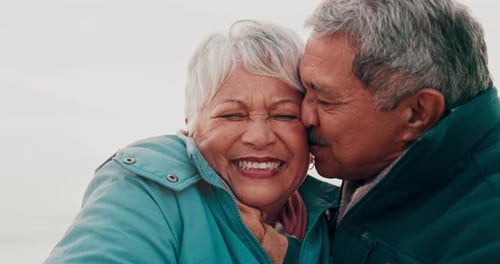 Affectionate Senior Couple Sharing Loving Moment at Beach