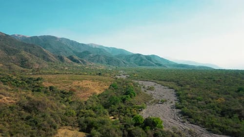 Aerial drone flying over a blue water lake with mountains landscape