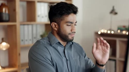 Stressed Man Rubbing Forehead in Office Workplace