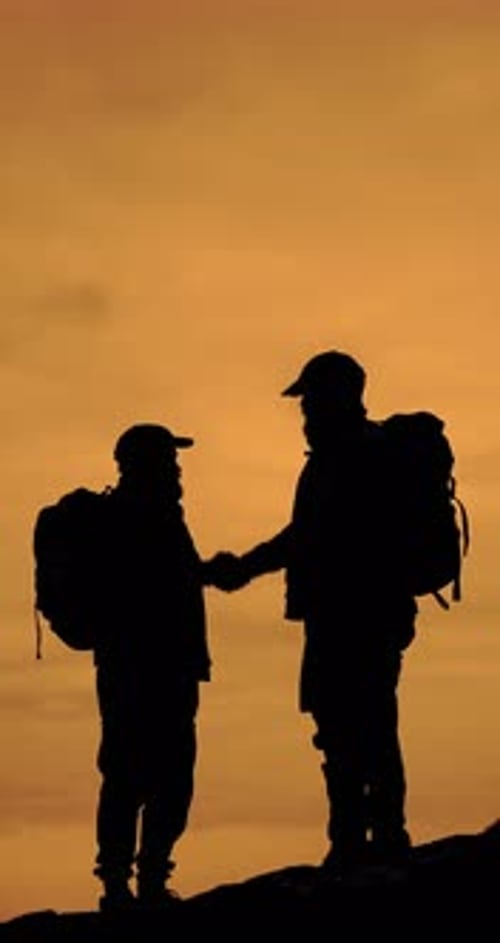 Silhouette of Two Men Hiking at Sunset