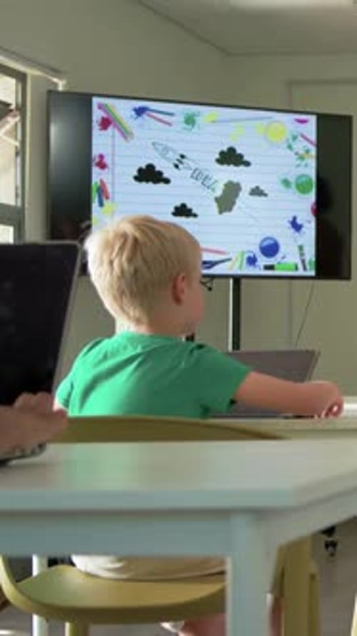Rocket slide appearing causing student looking between tablet and display, raising hand answering