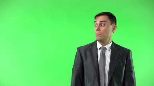 Astonished Man in Suit Touching Cheek in Studio