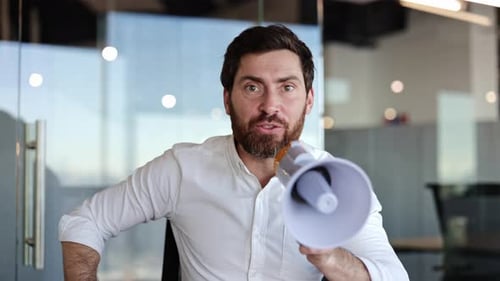 Businessman Making an Announcement with Megaphone in Office