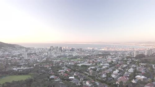 4k drone footage of a city by the mountainside