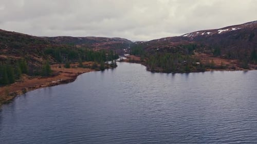 Calm Waters Of Reinsjoen Lake At Sunset In Norway. Aerial Pullback Shot