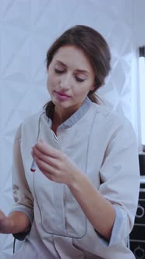 Woman Examines Medical Test in Modern Clinic Setting