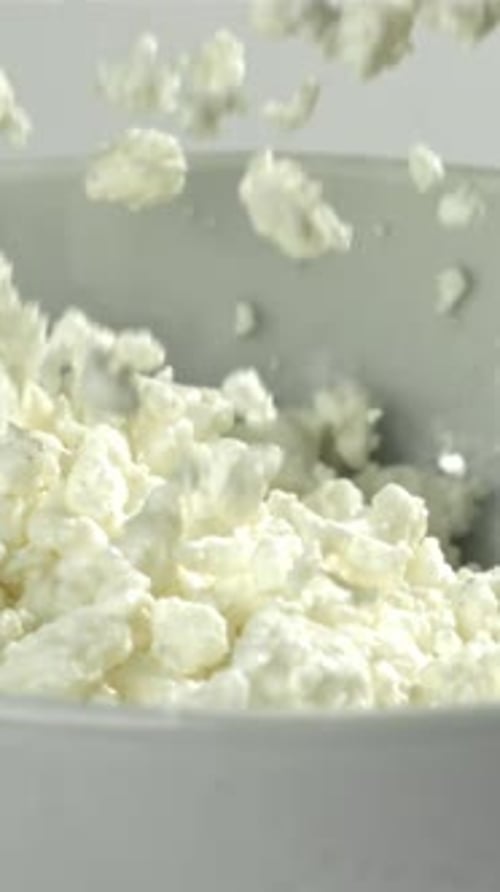Fresh Cottage Cheese Falls Into the Bowl Filmed on a Highspeed Camera at 1000 Fps