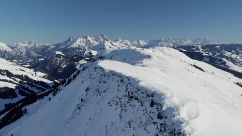 Snowy Mountain Ridges On A Sunny Day Near Saalbach-Hinterglemm Ski Resort In Austria. Aerial Drone S