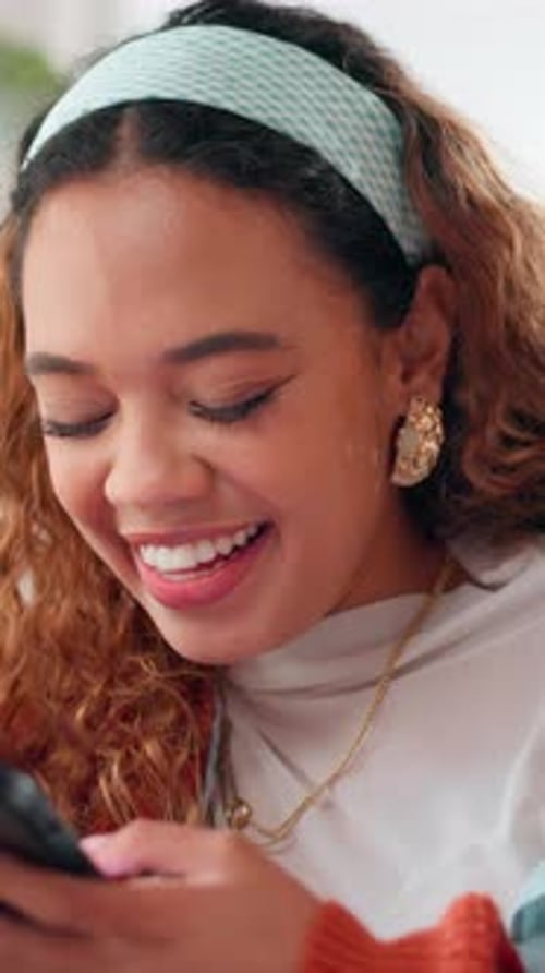 Smiling Woman Using Mobile Phone Indoors