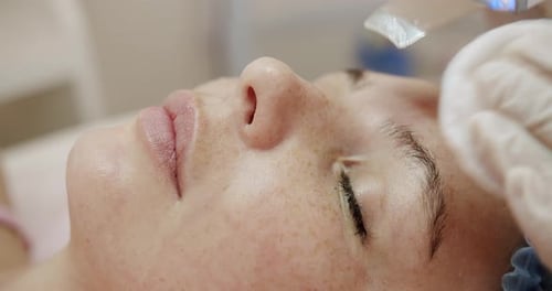 Woman receiving a facial cosmetic procedure