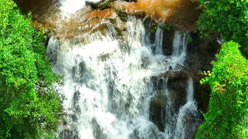 Tropical Waterfall Cascades Through Lush Greenery