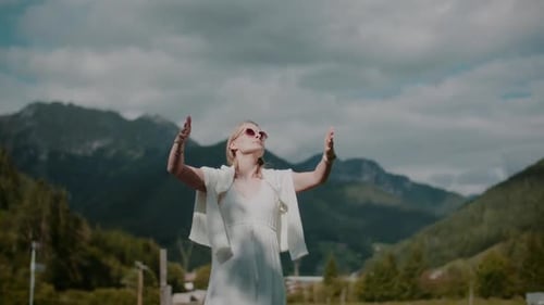 Woman Posing Outdoors with Arms Outstretched