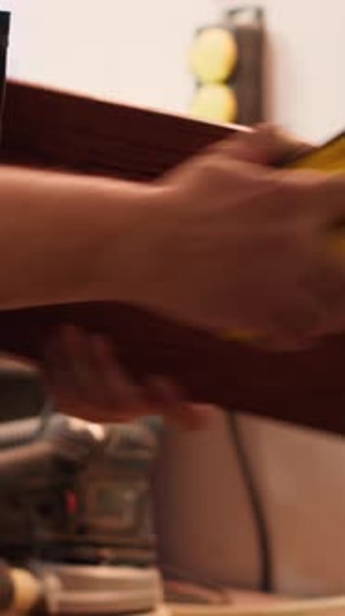 Woodworker Smoothing Wood Edges with Sanding Block