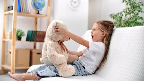 Baby Girl Playing to Bear Soft Toy Talking Hugging Enjoy Friendship and Support at Home White Room