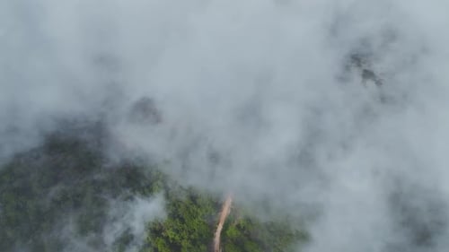 Aerial View Magical CloudCovered Mountains With Green Forest and Open Fields