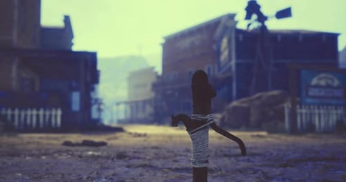 Desolate Western Town Street with Tied Post and Wooden Buildings at Dusk