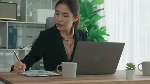 Enthusiastic Businesswoman Working and Typing Laptop in the Office